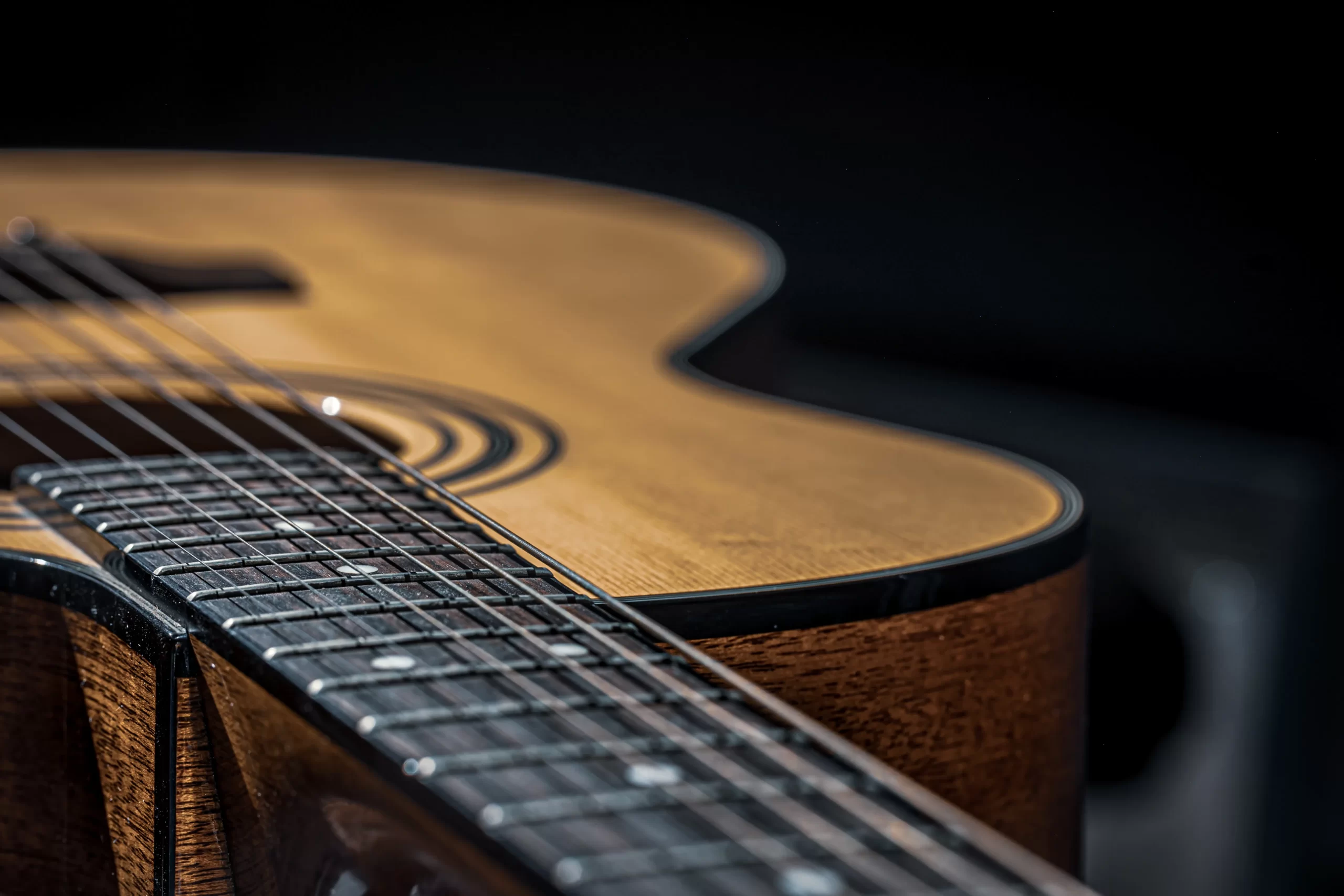 part-acoustic-guitar-guitar-fretboard-with-strings-black-background-with-highlights